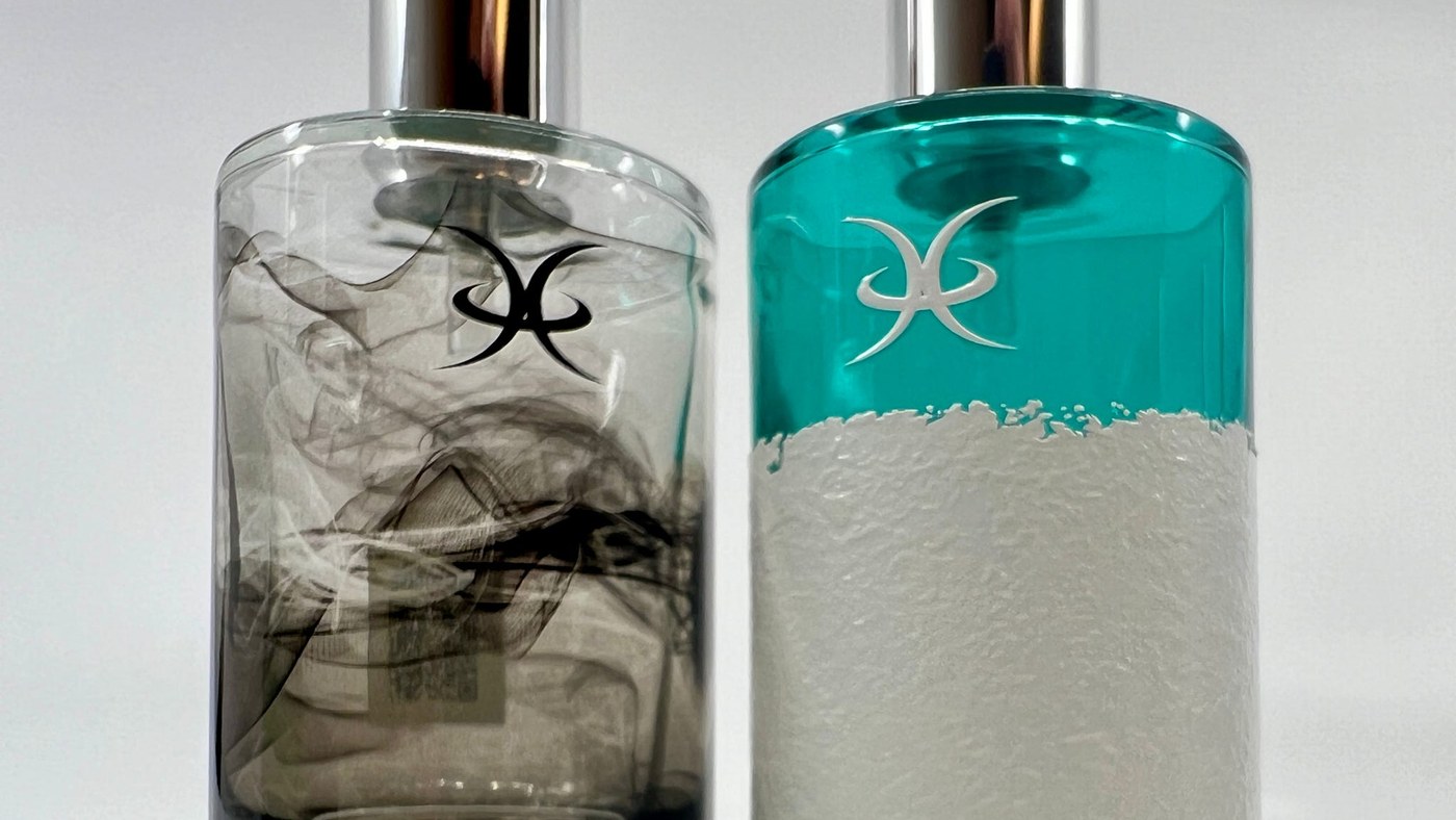 Two glass perfume bottles printed direct, one with a translucent smoke design and one with a textured white band under a teal field