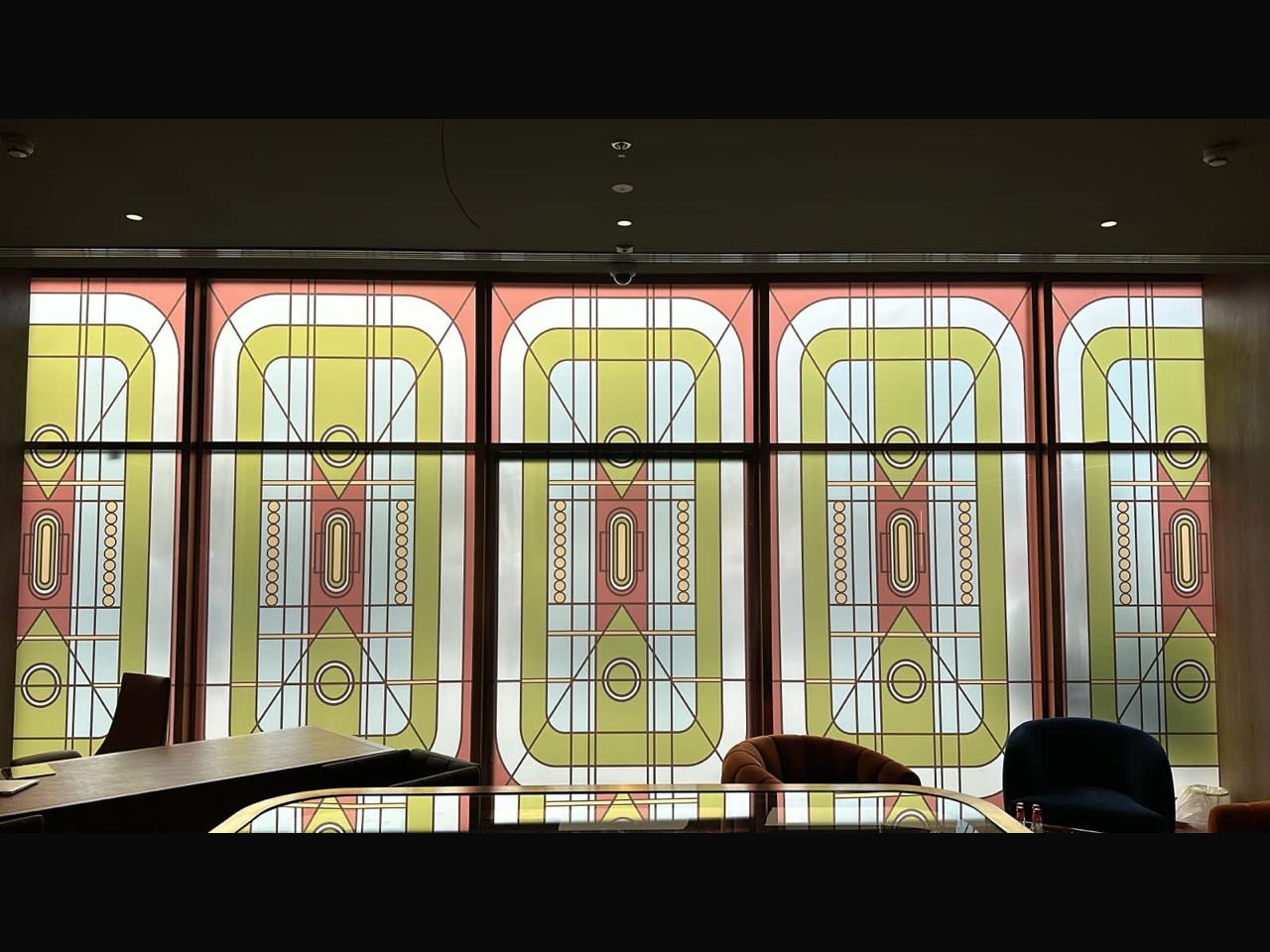 Printed architectural glass panel with a layered geometric pattern in a Dubai office