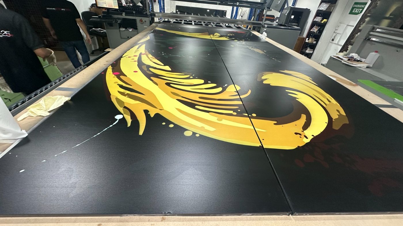 A gold scroll motif printed direct onto the black face of an ACP panel