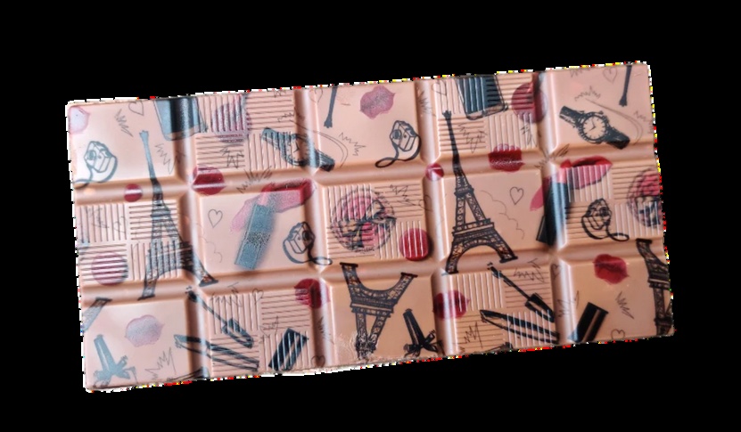 A white chocolate bar printed edge to edge with a Paris illustration in pink and navy, in edible ink