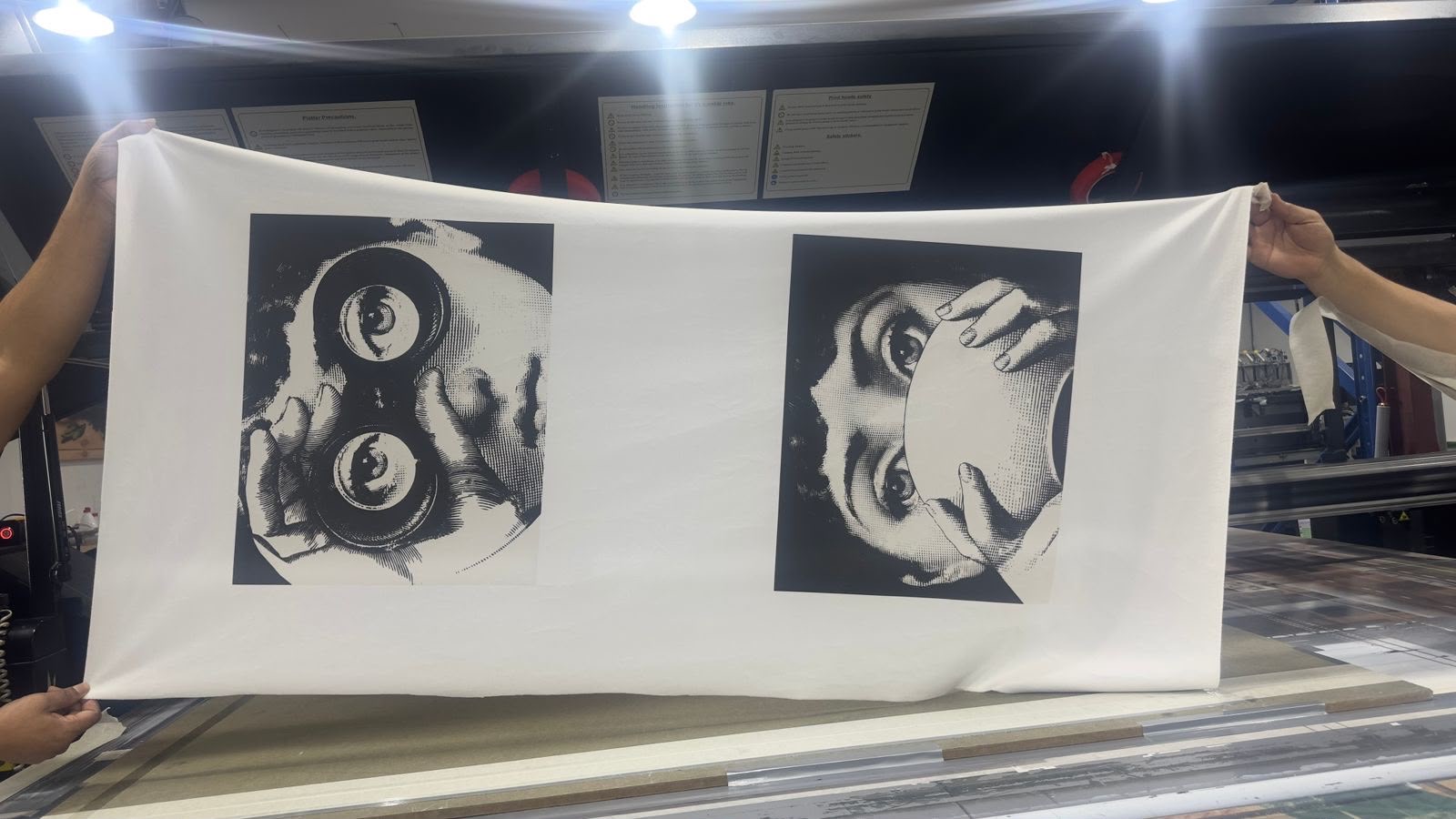A printed fabric panel held up in the Sun Studio workshop