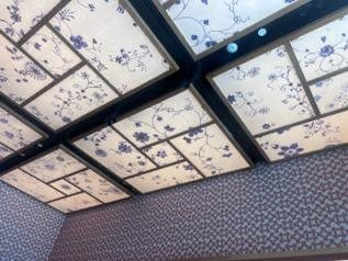The printed linen panels installed as backlit ceiling coffers in the restaurant