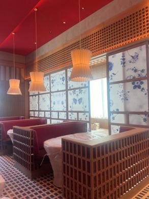 Printed linen screens in the restaurant windows alongside the timber joinery and banquettes