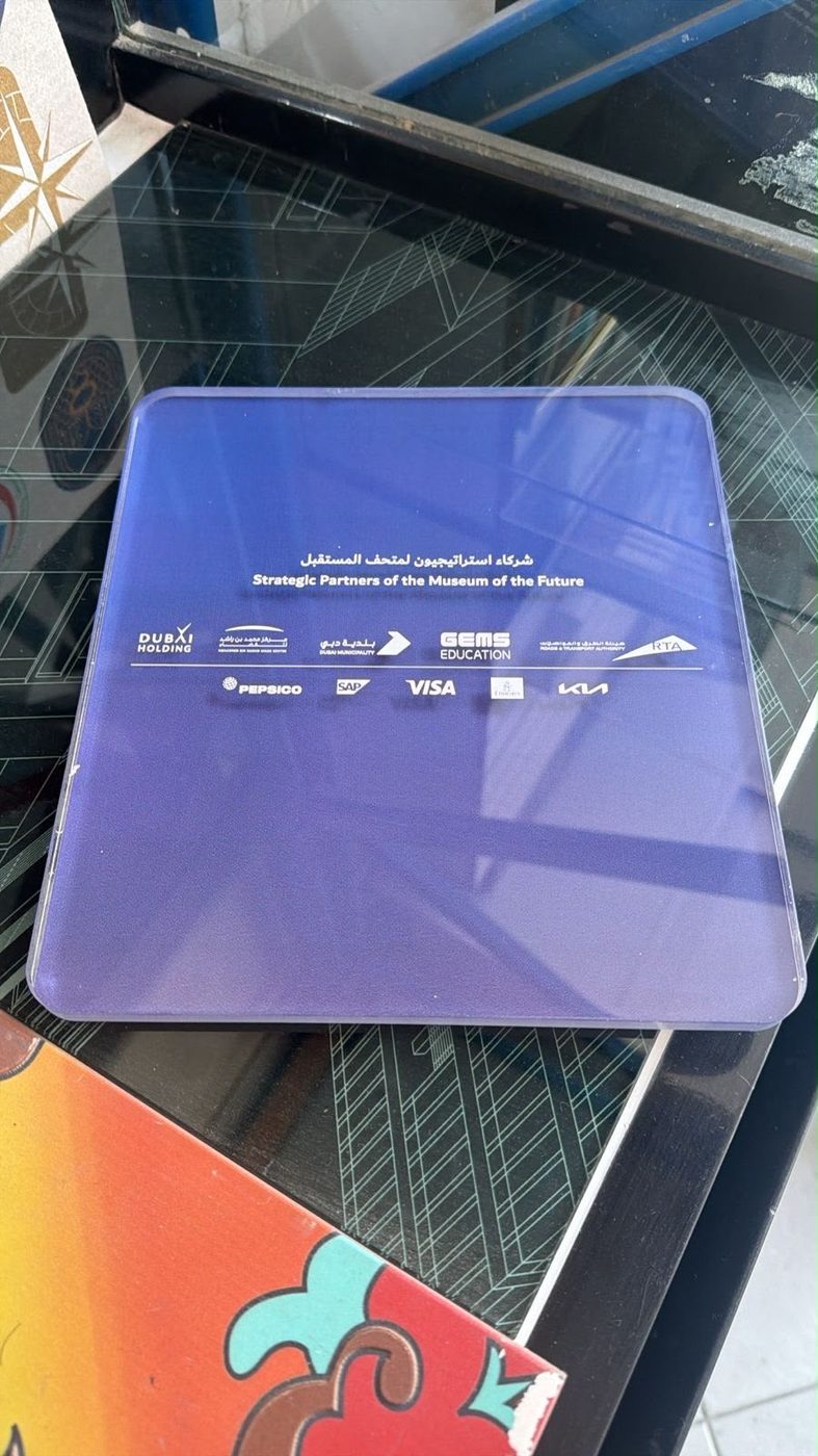 A printed partner plaque for the Museum of the Future with bilingual text and partner logos in full colour