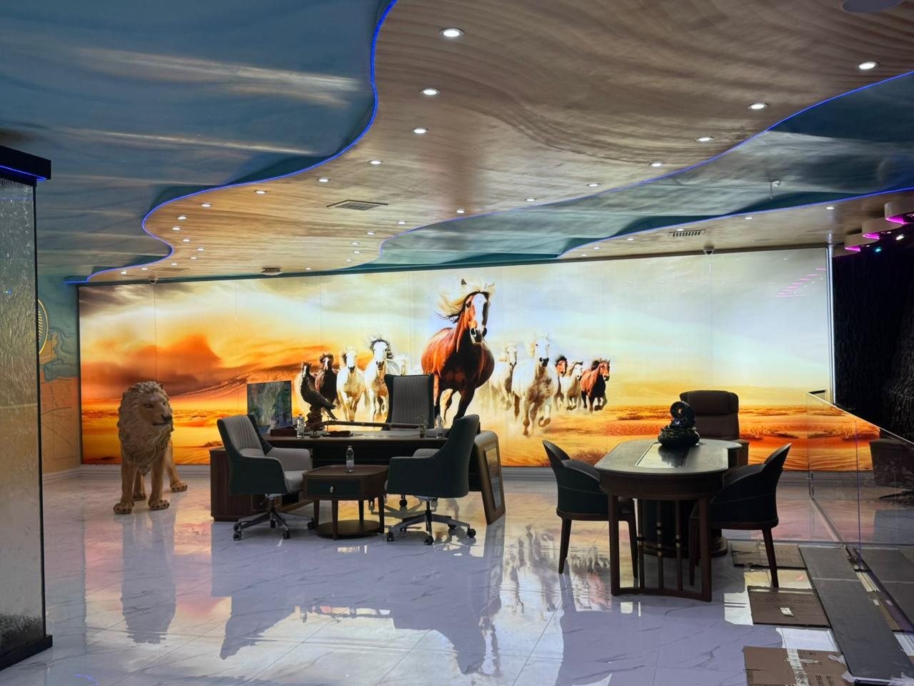 A ten metre wide printed glass wall of running horses and desert at sunset in the DreamDraw CEO office in Dubai