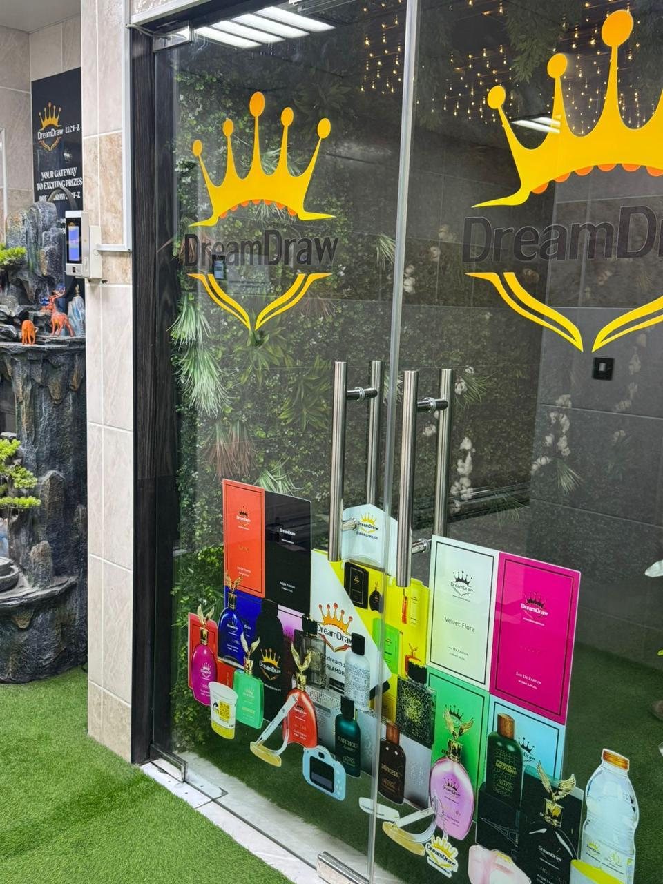Shopfront glazing printed with the DreamDraw crown mark above the product display