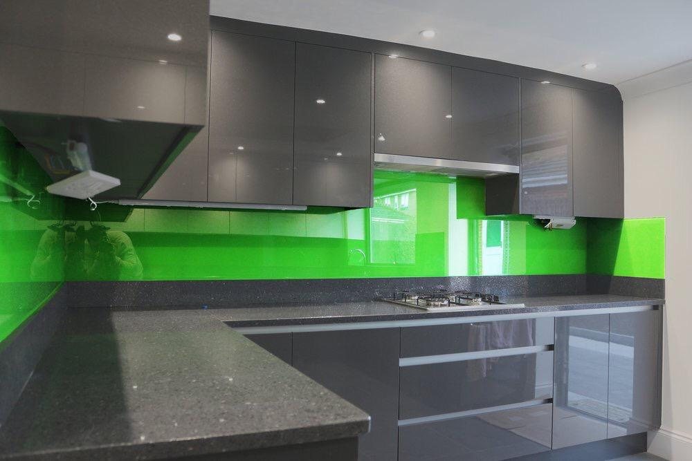 A deep aubergine reverse printed glass kitchen splashback behind an oak worktop and induction hob