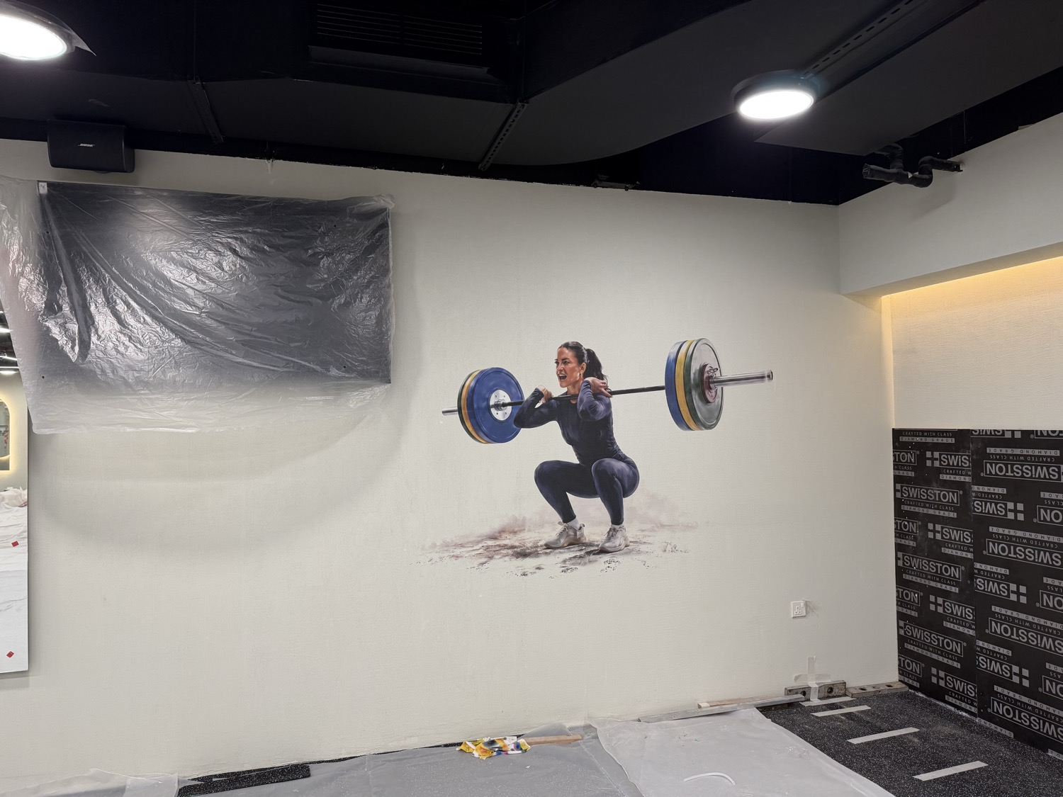 Weightlifting artwork printed directly onto the training floor wall at Body Abs Gym Abu Dhabi