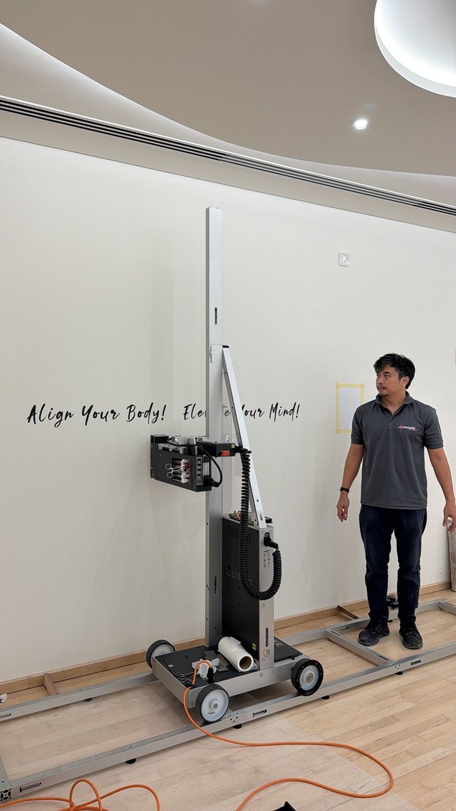The wallPen printing script lettering directly onto a wall at Body Abs Gym, Abu Dhabi