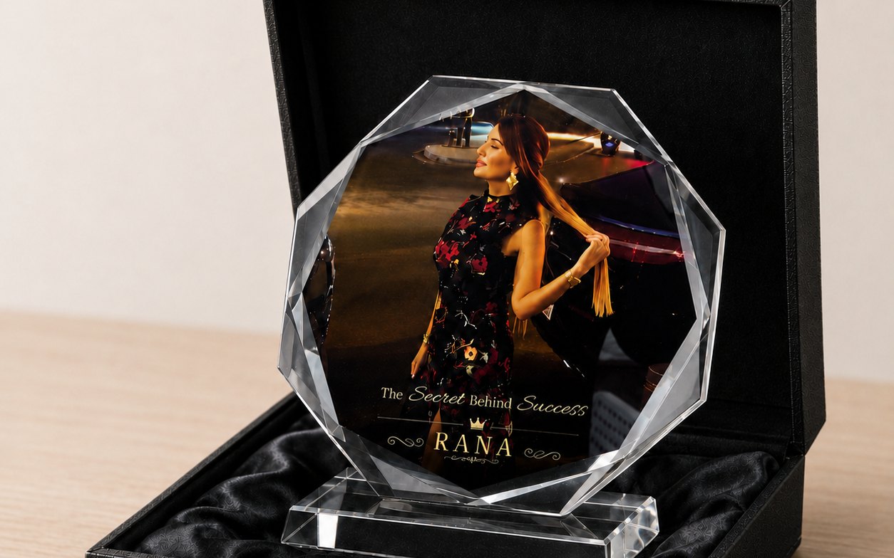 An octagonal crystal award printed in full colour with a photograph and gold lettering, presented in a black gift box