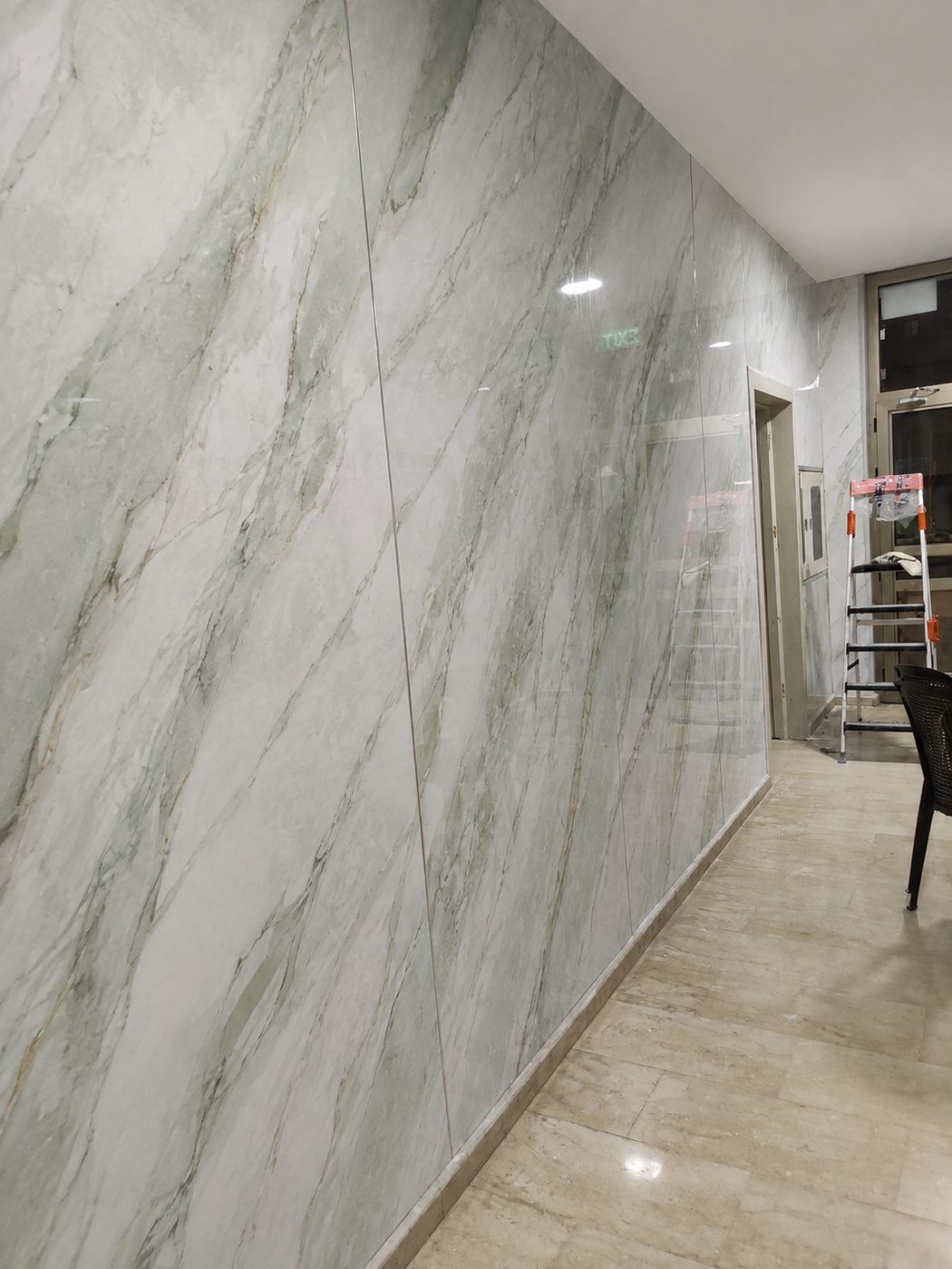 A marble-clad interior wall in Dubai, the kind of stone surface Sun Studio prints onto