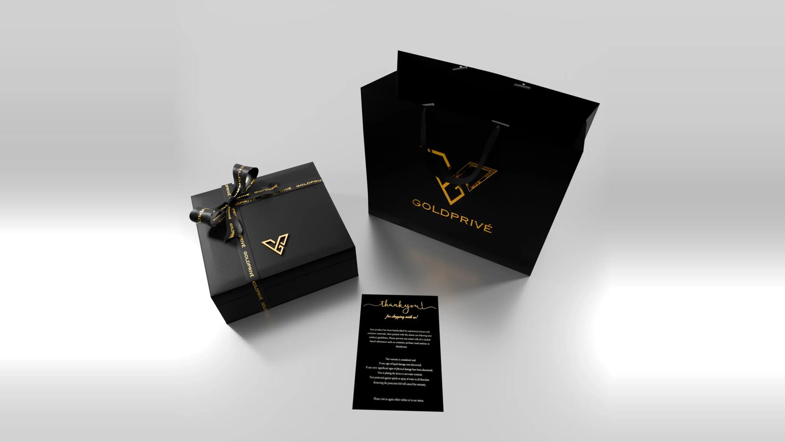 A black presentation box tied with a black and gold ribbon, a black carrier bag with the gold GoldPrivé logo and a black thank-you card, on a pale grey background